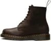 A single brown Dr. Martens boot is shown against a white background. Voir les images du produit
