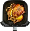 A whole roasted chicken with lemon slices and dried lemon slices inside an air fryer basket. Produktbild-Vorschau