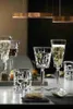 A table setting with crystal glasses and appetizers, illuminated by modern pendant lights. Podgląd zdjęcia produktu