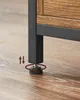 A close-up of the adjustable foot of a table leg on a wooden floor. Náhled obrázku produktu