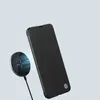 A black flip phone case is shown next to a wireless charger. Produktbild-Vorschau