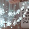 A close-up of snowflake-shaped LED string lights, likely for holiday decoration. Náhled obrázku produktu