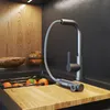 A modern kitchen sink area with a pull-down faucet and oranges in a cutting board. Náhled obrázku produktu