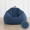 A blue bean bag chair is shown on a wooden floor in front of a white wall. Voir les images du produit