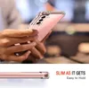 A person holding a transparent phone case with a pink phone inside. Produktbild-Vorschau