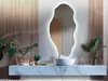 A modern bathroom vanity with a sink, mirror, and plants. Produktbild-Vorschau
