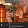 People gathered outdoors, eating and socializing around a patio heater. Produktbild-Vorschau