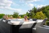 A couple relaxing in a hot tub outdoors on a sunny day. Produktbild-Vorschau