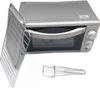 A top-down view of a small kitchen oven with its door open, revealing a wire rack inside. A separate wire accessory is placed in front of the oven. Produktbild-Vorschau
