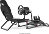 A racing simulator cockpit with a seat, steering wheel, and pedals, shown against a white background. Produktbild-Vorschau