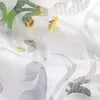 A close-up view of a white sheer curtain with an embossed floral pattern. Produktbild-Vorschau