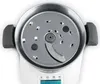 A top-down view of the inside of a kitchen appliance with a metal blade attachment. Produktbild-Vorschau