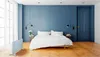 A bedroom scene with a bed, a door, and a heater. Produktbild-Vorschau