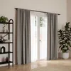 A room with a window covered by gray curtains, a bookshelf, and a potted plant. Podgląd zdjęcia produktu