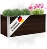 A brown rectangular planter box filled with green plants and pink flowers, with a diagonal white banner featuring the German flag and text. Produktbild-Vorschau