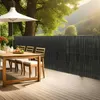 A patio dining set with a privacy screen in a garden setting. Náhľad obrázku produktu
