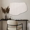 A modern vanity or desk area with a chair, mirror, and decorative items. Produktbild-Vorschau