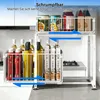 A kitchen counter with a two-tier storage organizer holding bottles and cans. Voir les images du produit