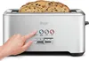 A hand is pressing a button on a silver Sage toaster with bread inside. Produktbild-Vorschau