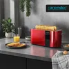 A red toaster with toast and orange juice on a kitchen counter. Náhled obrázku produktu
