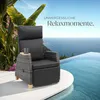 A rattan armchair with a cup holder and mug sits on a white platform next to an infinity pool overlooking the ocean. Náhled obrázku produktu