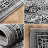 A collage of four close-up images showing different angles and details of a gray oriental rug with a black and white pattern. Produktbild-Vorschau