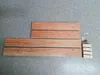 Wooden planks and hardware laid out on a speckled gray surface. Produktbild-Vorschau