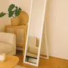 A full-length mirror stands in a room next to a wooden cabinet and a sofa. Náhľad obrázku produktu
