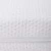 A close-up view of a white textured fabric, likely a mattress cover, with a visible zipper. Produktbild-Vorschau