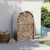 A firewood rack filled with wood, placed next to a white wall, with a broom and bucket nearby. Náhľad obrázku produktu