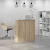 A reception desk in an office setting with a chair and shelving unit. Anteprima dell’immagine prodotto