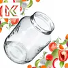 A clear glass jar is shown tilted on a white background, surrounded by various fresh vegetables and herbs. Podgląd zdjęcia produktu