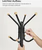 A person is assembling a black coat rack with wooden knobs. Náhled obrázku produktu