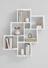 A white modular shelving unit is mounted on a light gray wall, showcasing various decorative items and books arranged within its compartments. Produktbild-Vorschau