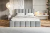 A modern bedroom with a light gray upholstered bed as the focal point. Náhled obrázku produktu