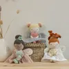 Three plush fairy dolls are displayed on a wooden surface in front of a neutral background. A woven basket is behind the dolls, and a vase with dried flowers is to the left. Náhľad obrázku produktu