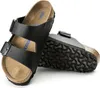 A pair of black Birkenstock sandals shown against a white background. Anteprima dell’immagine prodotto