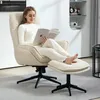 A woman is reading a book while sitting in a beige armchair with a matching ottoman. Voir les images du produit