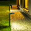 Solar pathway lights illuminate a stone walkway and lawn next to a building at night. Náhľad obrázku produktu