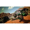 A monster truck is shown in mid-air, performing a jump over a dirt track in a desert-like environment. The truck features the 'Grave Digger' branding and a pirate flag. Produktbild-Vorschau