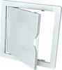 A white plastic inspection door with a hinged flap is shown against a white background. The flap is partially open, revealing the interior mechanism. Náhled obrázku produktu