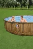 A family enjoying an above-ground swimming pool in a backyard setting. Produktbild-Vorschau