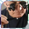 A jeweler examines a diamond with a loupe attached to his glasses. Produktbild-Vorschau