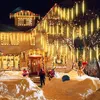 A house decorated with Christmas lights and snow. Produktbild-Vorschau