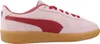 A side view of a pink Puma sneaker with red accents and a gum sole. Produktbild-Vorschau