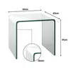 A clear, well-lit studio shot of a transparent U-shaped glass side table with dimensions indicated by lines and text. Produktbild-Vorschau