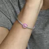 A close-up shot of a person's arm wearing a silver bracelet with a pink flower charm. Produktbild-Vorschau