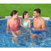 A family enjoying themselves in an above-ground swimming pool on a sunny day. Produktbild-Vorschau