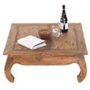 A wooden coffee table with a book, wine bottle, and glasses on it. Náhľad obrázku produktu