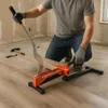 A person is using a laminate and vinyl floor cutter to cut a piece of flooring. Produktbild-Vorschau